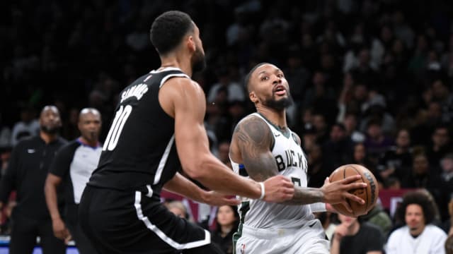  Milwaukee Bucks guard Damian Lillard (0) drives to the basket against Brooklyn Nets guard Ben Simmons (10) 